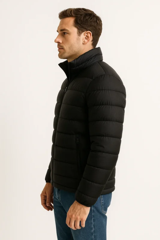 A model wearing a men's puffy jacket in a realistic lighting side studio posture.