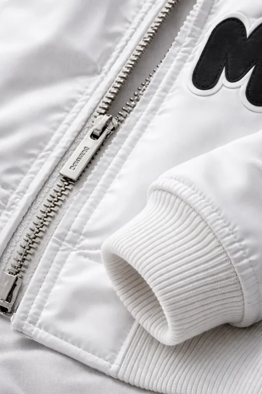 LifestylClose up fabric and zipper detail of Marshmello White Bomber Jackete image showing how the Marshmello White Bomber Jacket can be styled casually with dark jeans and sneakers for an everyday street look.