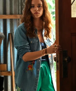 Bring screen-inspired fashion to your wardrobe with the Sadie Soverall Every Year After 2026 Embroidered Denim Snap-Up Shirt. Inspired by the character Percy Fraser, portrayed by Sadie Soverall in the romantic drama series Every Year After, this stylish blue denim shirt captures the relaxed, nature-inspired aesthetic seen throughout the show. Crafted from premium-quality denim, this women's snap-up shirt features eye-catching embroidered mushroom artwork that adds a playful boho touch to a timeless wardrobe staple. The classic shirt collar, dual flap chest pockets, and comfortable relaxed fit make it ideal for layering over tanks, tees, or dresses throughout every season. With embroidered denim continuing to trend in contemporary fashion, this versatile piece blends vintage charm with modern casual style, making it perfect for everyday wear, travel outfits, festivals, and weekend adventures. Whether you're a fan of Every Year After or simply looking for a standout embroidered denim shirt, this Percy Fraser-inspired piece delivers comfort, character, and effortless style.