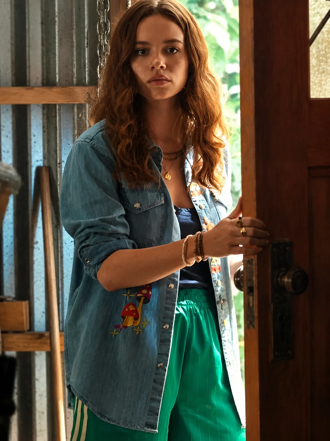 Bring screen-inspired fashion to your wardrobe with the Sadie Soverall Every Year After 2026 Embroidered Denim Snap-Up Shirt. Inspired by the character Percy Fraser, portrayed by Sadie Soverall in the romantic drama series Every Year After, this stylish blue denim shirt captures the relaxed, nature-inspired aesthetic seen throughout the show. Crafted from premium-quality denim, this women's snap-up shirt features eye-catching embroidered mushroom artwork that adds a playful boho touch to a timeless wardrobe staple. The classic shirt collar, dual flap chest pockets, and comfortable relaxed fit make it ideal for layering over tanks, tees, or dresses throughout every season. With embroidered denim continuing to trend in contemporary fashion, this versatile piece blends vintage charm with modern casual style, making it perfect for everyday wear, travel outfits, festivals, and weekend adventures. Whether you're a fan of Every Year After or simply looking for a standout embroidered denim shirt, this Percy Fraser-inspired piece delivers comfort, character, and effortless style.