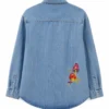 Bring screen-inspired fashion to your wardrobe with the Sadie Soverall Every Year After 2026 Embroidered Denim Snap-Up Shirt. Inspired by the character Percy Fraser, portrayed by Sadie Soverall in the romantic drama series Every Year After, this stylish blue denim shirt captures the relaxed, nature-inspired aesthetic seen throughout the show. Crafted from premium-quality denim, this women's snap-up shirt features eye-catching embroidered mushroom artwork that adds a playful boho touch to a timeless wardrobe staple. The classic shirt collar, dual flap chest pockets, and comfortable relaxed fit make it ideal for layering over tanks, tees, or dresses throughout every season. With embroidered denim continuing to trend in contemporary fashion, this versatile piece blends vintage charm with modern casual style, making it perfect for everyday wear, travel outfits, festivals, and weekend adventures. Whether you're a fan of Every Year After or simply looking for a standout embroidered denim shirt, this Percy Fraser-inspired piece delivers comfort, character, and effortless style.