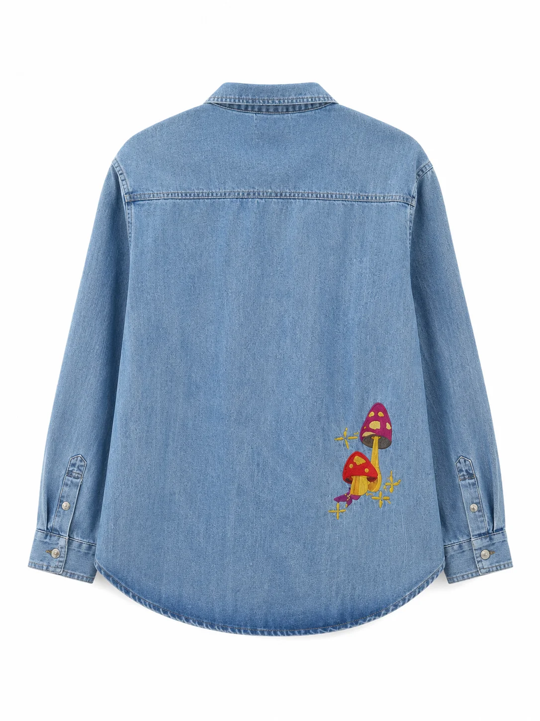Bring screen-inspired fashion to your wardrobe with the Sadie Soverall Every Year After 2026 Embroidered Denim Snap-Up Shirt. Inspired by the character Percy Fraser, portrayed by Sadie Soverall in the romantic drama series Every Year After, this stylish blue denim shirt captures the relaxed, nature-inspired aesthetic seen throughout the show. Crafted from premium-quality denim, this women's snap-up shirt features eye-catching embroidered mushroom artwork that adds a playful boho touch to a timeless wardrobe staple. The classic shirt collar, dual flap chest pockets, and comfortable relaxed fit make it ideal for layering over tanks, tees, or dresses throughout every season. With embroidered denim continuing to trend in contemporary fashion, this versatile piece blends vintage charm with modern casual style, making it perfect for everyday wear, travel outfits, festivals, and weekend adventures. Whether you're a fan of Every Year After or simply looking for a standout embroidered denim shirt, this Percy Fraser-inspired piece delivers comfort, character, and effortless style.